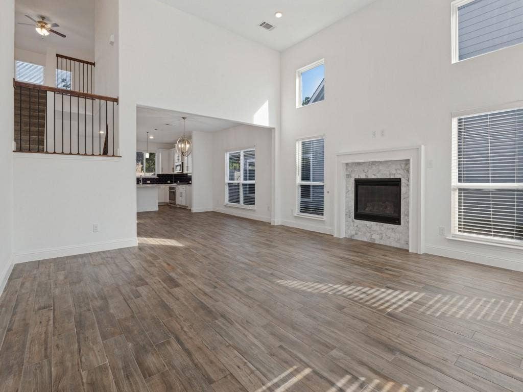 336 Clark Street, Irving, TX 75060 Open living area with wood-look tile flooring and views of the upstairs loft