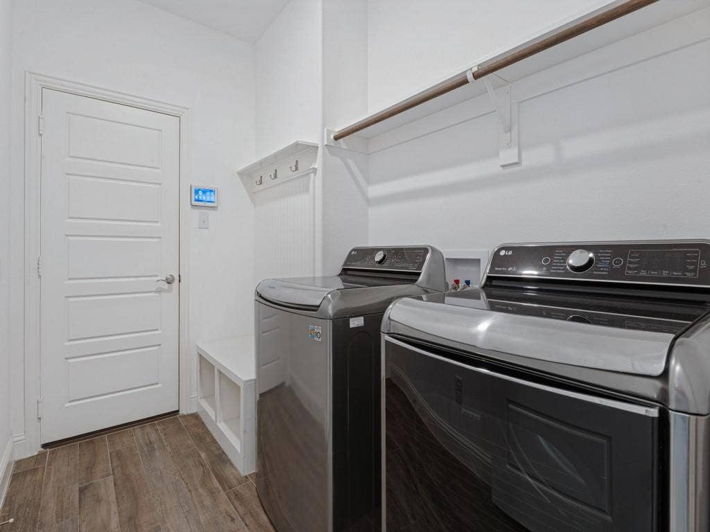 336 Clark Street, Irving, TX 75060 Dedicated laundry room with overhead shelving and space for a full-size washer and dryer