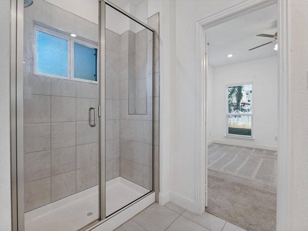 336 Clark Street, Irving, TX 75060 Spacious primary shower with tile surround and a glass enclosure.