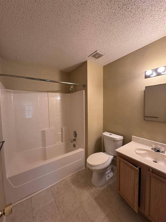 Full bathroom featuring a tub-shower combination, vanity with integrated basin, medicine cabinet, and tiled flooring
