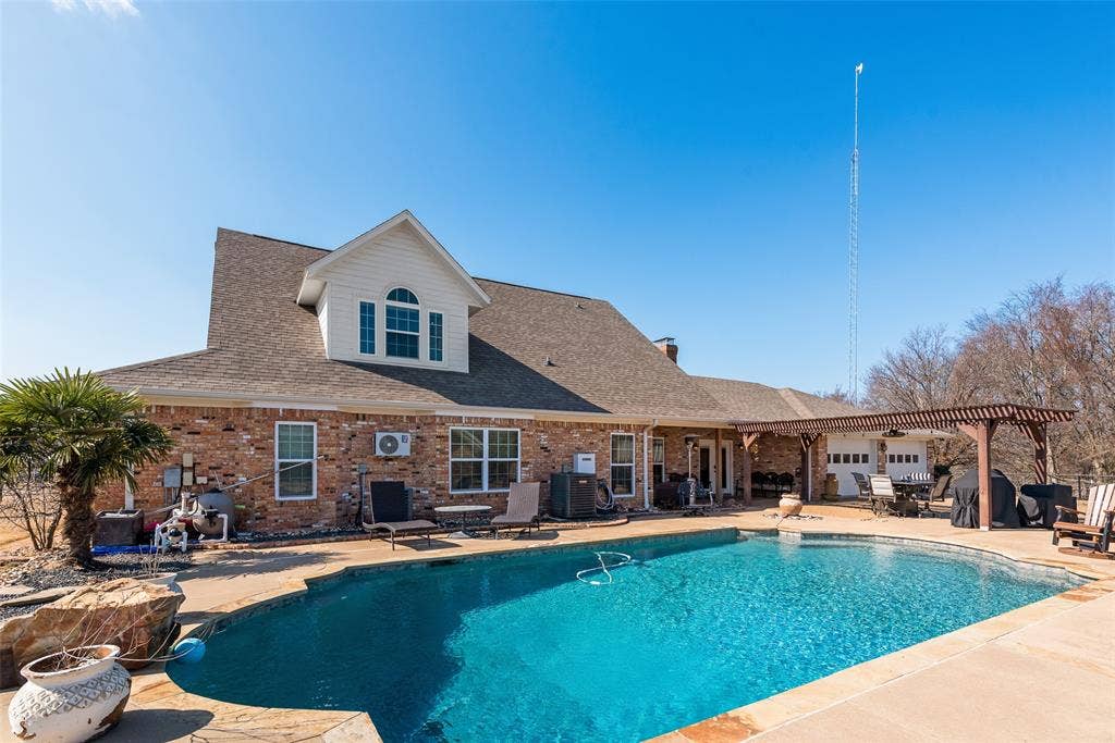 Rear entry driveway goes all the way around the pool