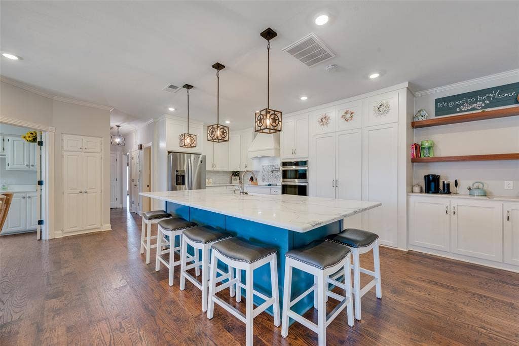 View of recent remodeled kitchen. Custom cabinets and quartz countertops. Stainless steel appliances and big farm sink.