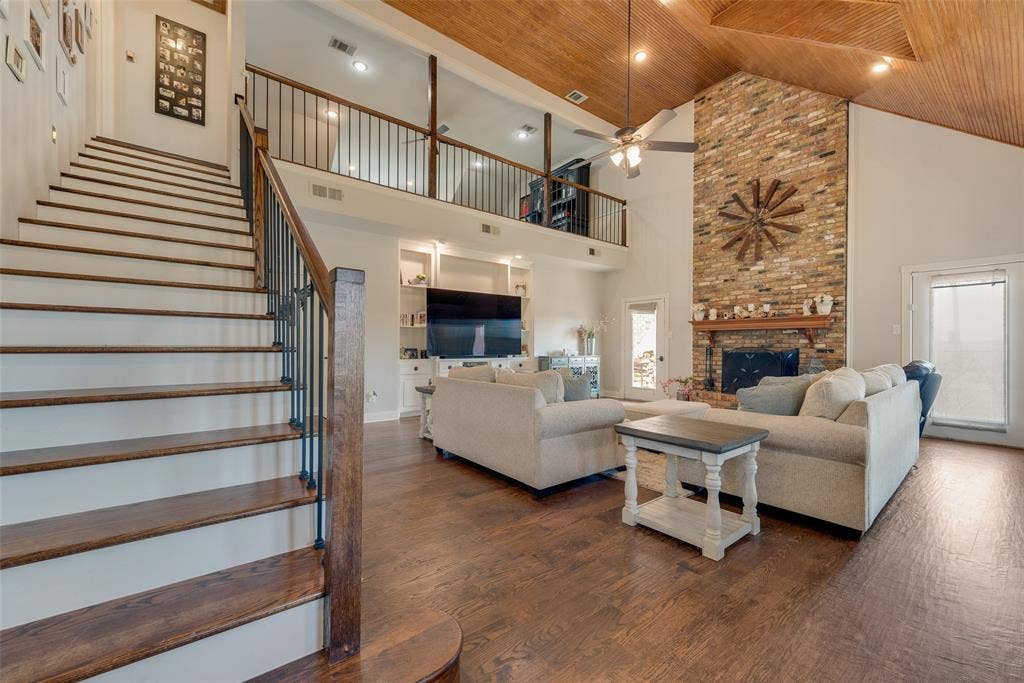 Beautiful custom stairway and huge living room with wood burning fireplace.