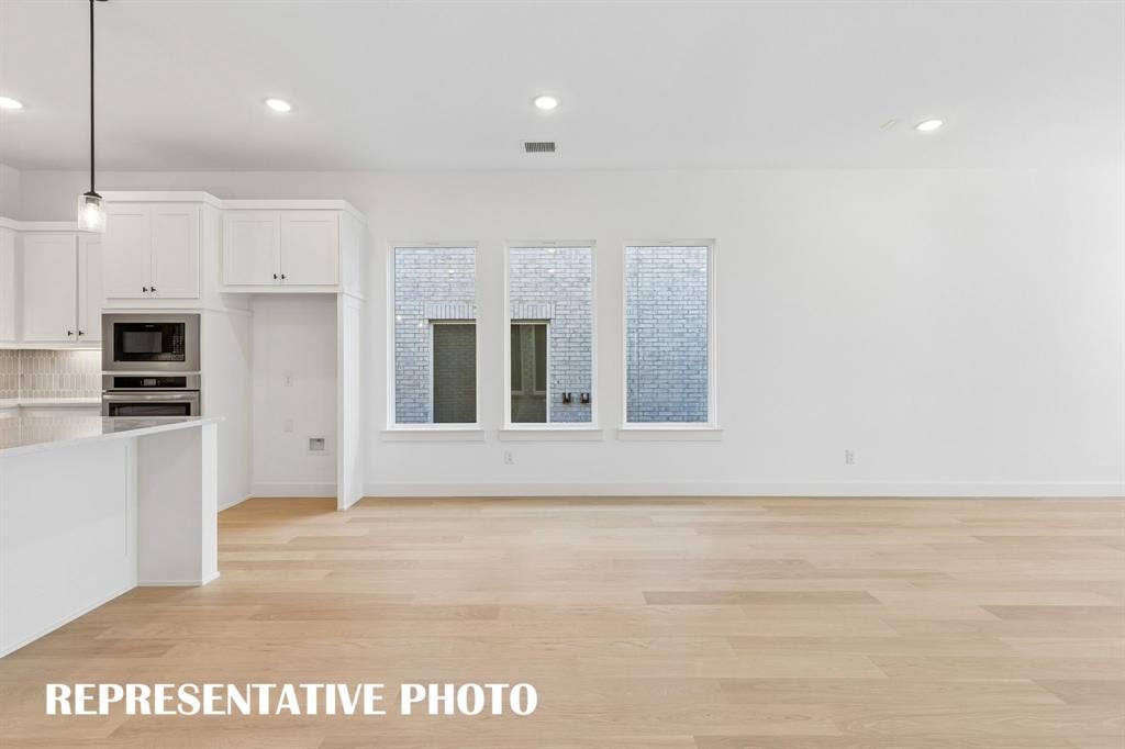 Conveniently located between the kitchen and family room, this light filled dining space is perfect for hosting lively dinner parties or cozy family get togethers.  REPRESENTATIVE PHOTO