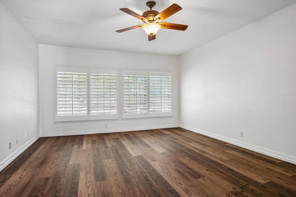 4611 O Connor Court, Irving, TX 75062 Primary bedroom , plantation shutters, and a central ceiling fan with an integrated light fixture