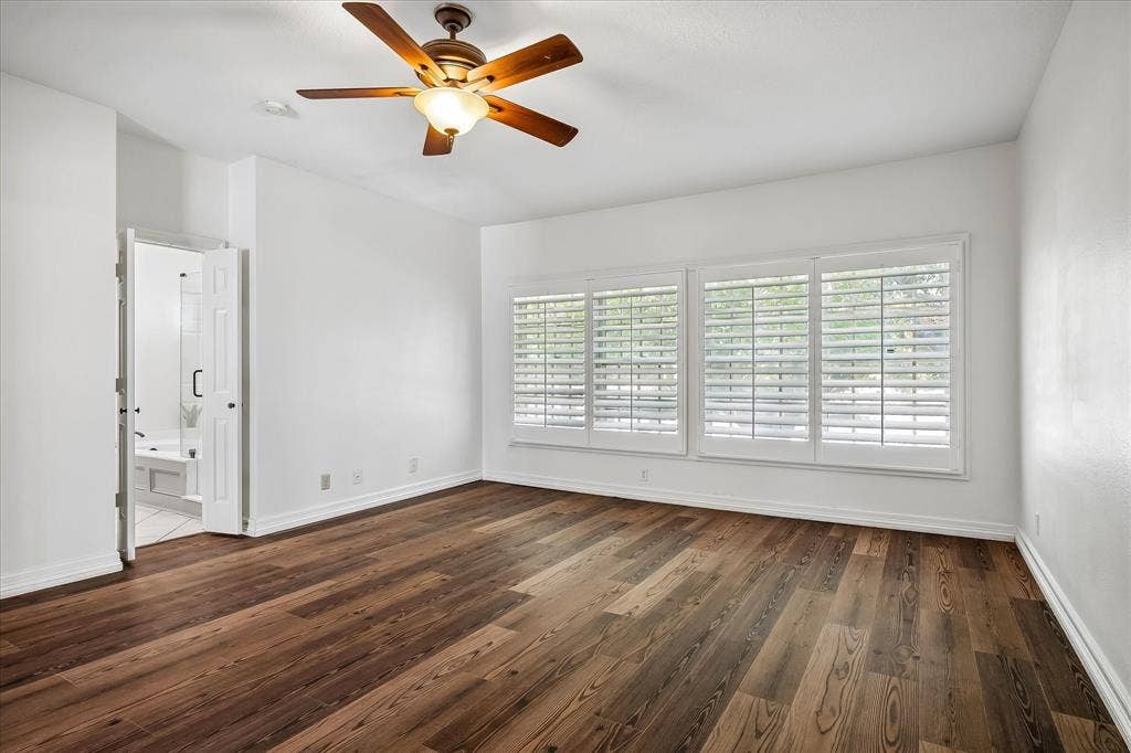 4611 O Connor Court, Irving, TX 75062 Room featuring VLP flooring, plantation shutters, and a ceiling fan with integrated lighting