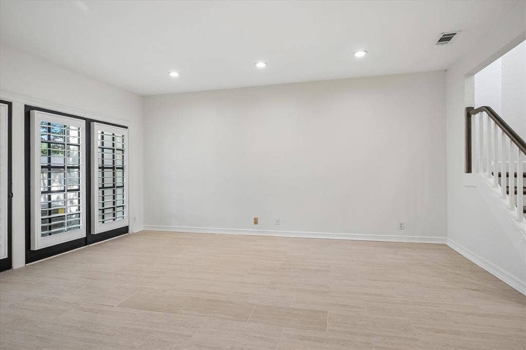 4611 O Connor Court, Irving, TX 75062 Neutral-toned wood-finish flooring, recessed lighting, and double glass-paneled doors with interior plantation shutters