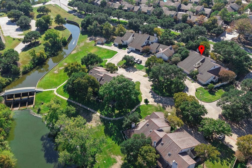 4611 O Connor Court, Irving, TX 75062 Aerial perspective of walkway to the Las Colinas Country Club featuring mature trees, expansive green space, and proximity to a waterway with a pedestrian bridge