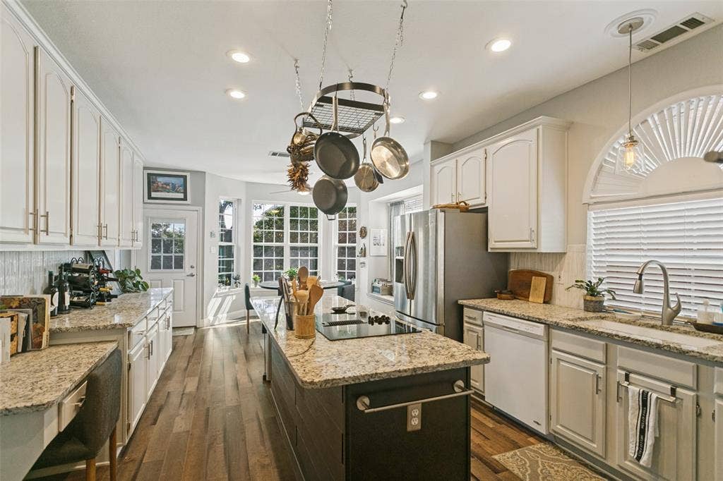 3212 Chippenham Drive, Plano, TX 75093 Kitchen featuring white shaker-style cabinetry, stone countertops, a center island with a built-in cooktop, recessed lighting, and wood-finish flooring
