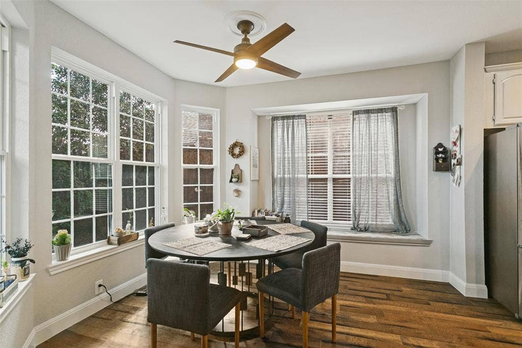 3212 Chippenham Drive, Plano, TX 75093 Multi-pane windows, wood-finish flooring, ceiling fan with integrated lighting, and a built-in window seat