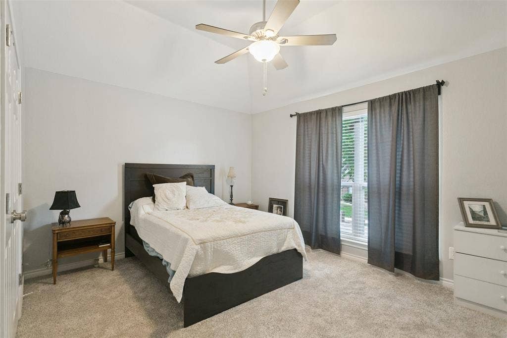3212 Chippenham Drive, Plano, TX 75093 Vaulted ceiling, neutral wall tones, neutral carpeting, and a multi-blade ceiling fan with integrated lighting