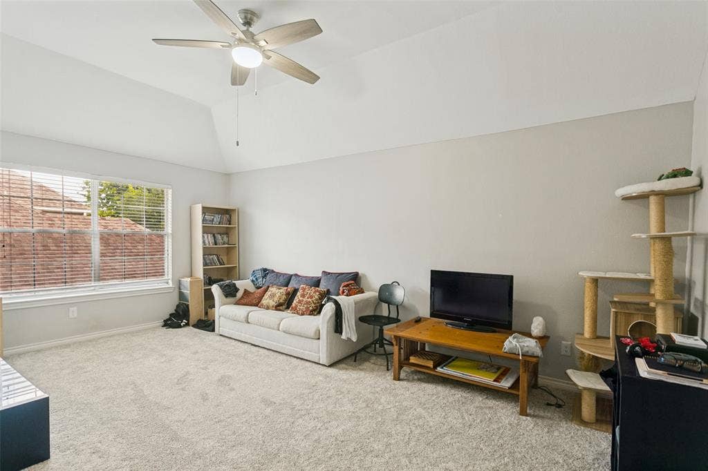 3212 Chippenham Drive, Plano, TX 75093 Vaulted ceilings, neutral wall tones, wall-to-wall carpeting, and a multi-blade ceiling fan with integrated lighting