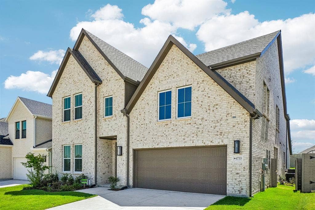 4733 Peary Lane, McKinney, TX 75071 Dramatic gables, beautiful light colored brick and striking dark trim create outstanding curb appeal for this dream home!