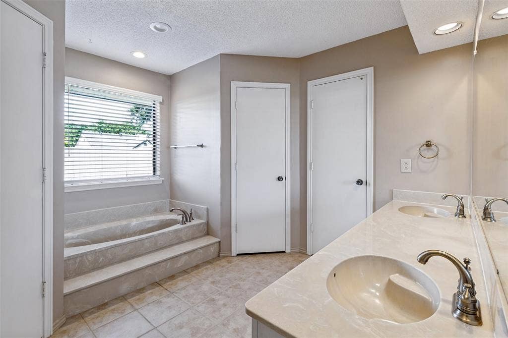 4063 Seabury Drive, Dallas, TX 75287 Two large walk in closets and double sinks.