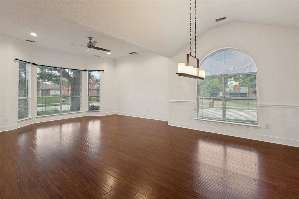 2306 Bent Brook Drive, Mesquite, TX 75181 Vaulted ceiling, wood-finish flooring, bay window, arched window, and linear multi-light pendant fixture