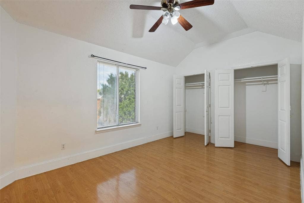 2306 Bent Brook Drive, Mesquite, TX 75181 Vaulted ceiling with integrated multi-light ceiling fan, wood-finish flooring, dual closets with panel doors, and window with horizontal blinds