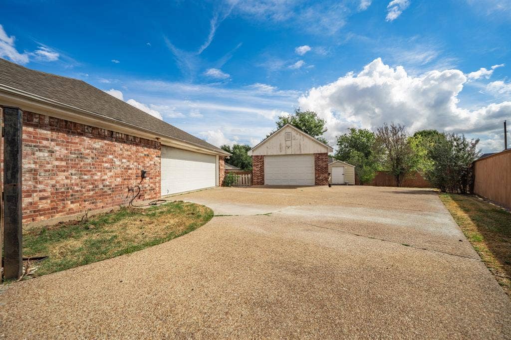 Side entry garage and detached garage, large concrete driveway, all behind gate for back yard.