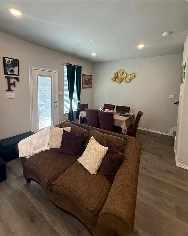 Wood-finish flooring, recessed lighting, and a glass-paneled exterior door