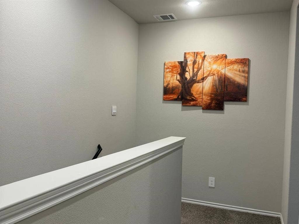 Neutral-toned interior walls, recessed lighting, and wall-mounted handrail