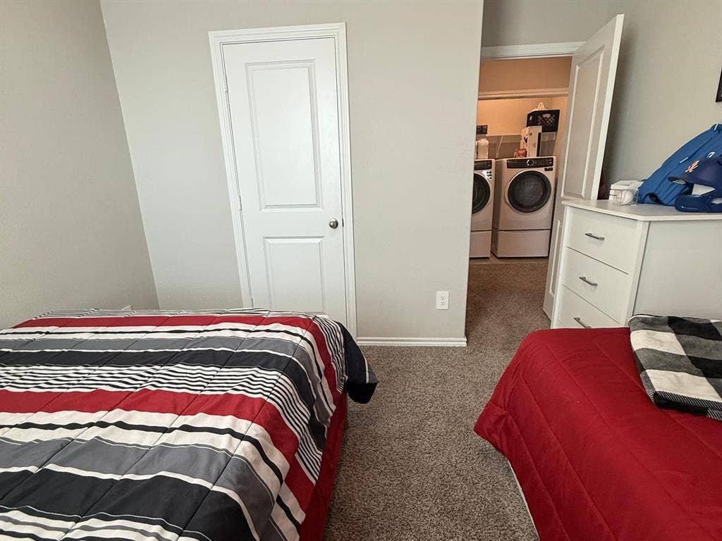Neutral-toned wall paint, neutral carpeting, and a two-panel interior door
