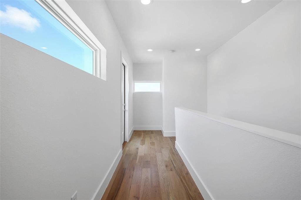 4904 Lexington Court, Dallas, TX 75206 Hallway featuring wood-finish flooring, recessed lighting, and multiple clerestory windows