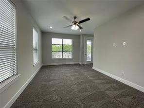 Neutral-toned interior featuring wall-to-wall carpeting, recessed lighting, a ceiling fan, and multi-pane windows