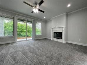 Fireplace with a classic white mantel, neutral carpeting, ceiling fan with integrated lighting, sliding glass doors, and recessed lighting