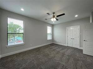 Neutral-toned interior featuring wall-to-wall carpeting, recessed lighting, a ceiling fan, and double panel doors