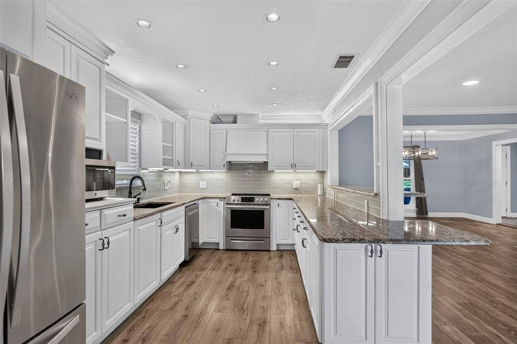3230 Camelot Drive, Dallas, TX 75229 The kitchen features a thoughtful blend of open and closed cabinets, giving you opens of both display space and convenient storage. Abundance of counter space for meal prep and entertaining. Who would not love all these cabinets?
