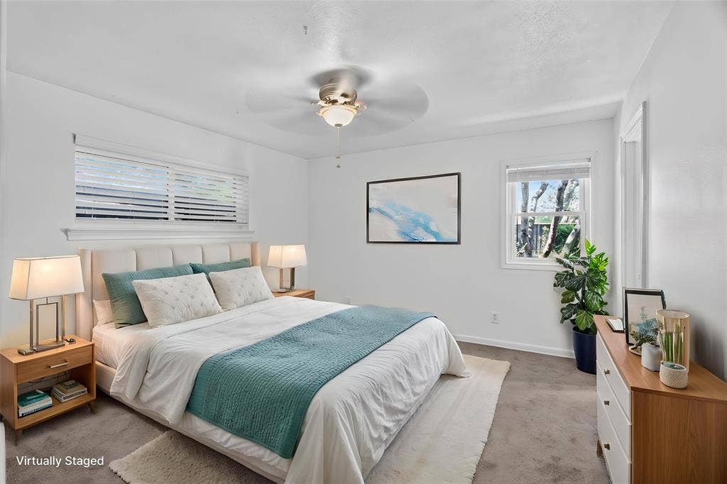 3230 Camelot Drive, Dallas, TX 75229 One of 3 bedrooms. Nice size, lots of window for natural light. Full size closet, ceiling-fan light fixture. August 2026 walls freshly painted. Rear door access to Jack N Jill bath. Wiindows look out on to gated private back yard.