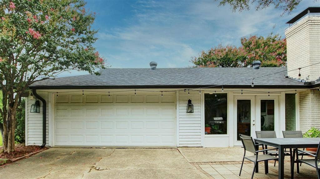 3230 Camelot Drive, Dallas, TX 75229 View of 2 stall garage with side entry as you enter in the front thru your driveway security gate. Plenty of additional parking in the rear of the house.