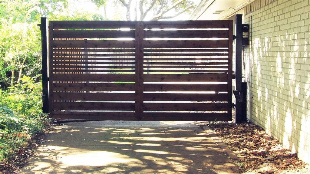3230 Camelot Drive, Dallas, TX 75229 Sellers updated the security gate with remote controls and new wood. Front entrance and backyard driveway has space for additional parking.