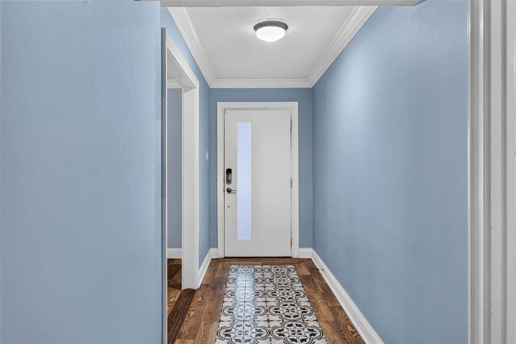 3230 Camelot Drive, Dallas, TX 75229 Love the mosaic inlaid tile foyer. Paint color brings out the blue in- the floor tiles. Note: walls had all texture removed and freshly painted for a smoother look. Redid transition pieces 2024.