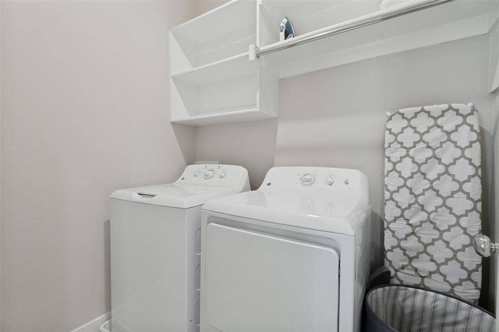 2808 Spring Side Drive, Royse City, TX 75189 Laundry area featuring built-in white shelving, an integrated hanging rod, and neutral wall tones