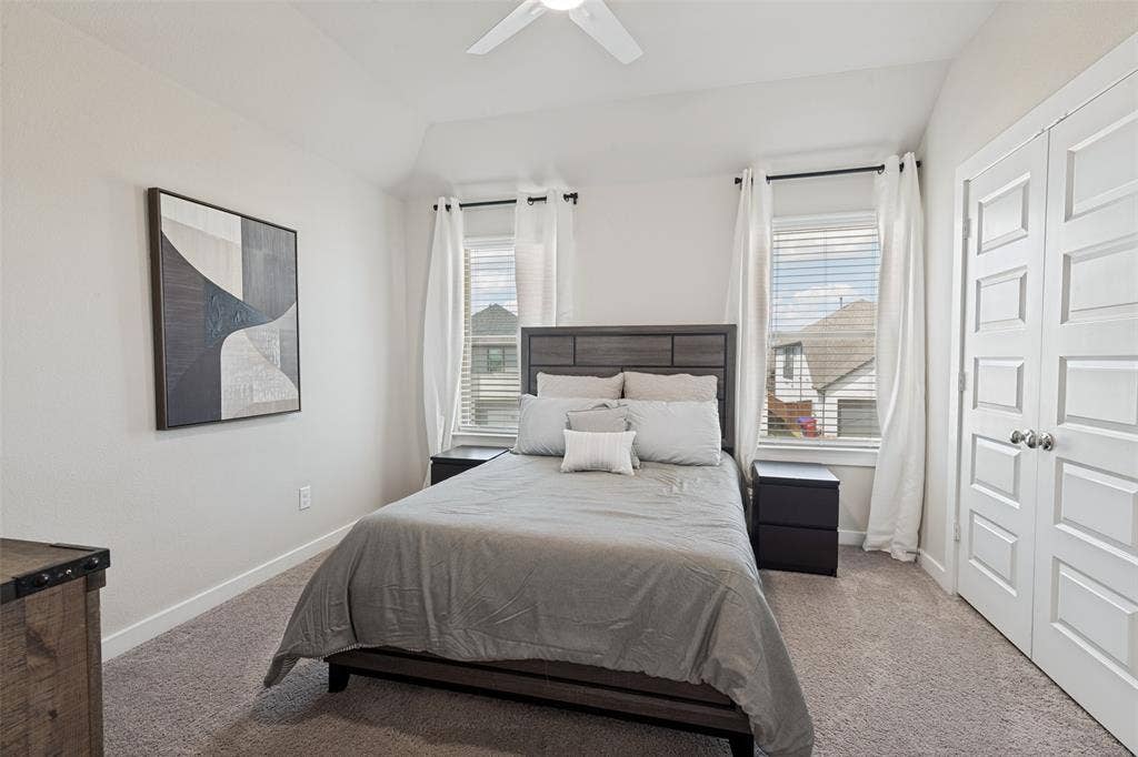 2808 Spring Side Drive, Royse City, TX 75189 Vaulted ceiling, neutral wall tones, dual windows with horizontal blinds, and a white paneled closet door