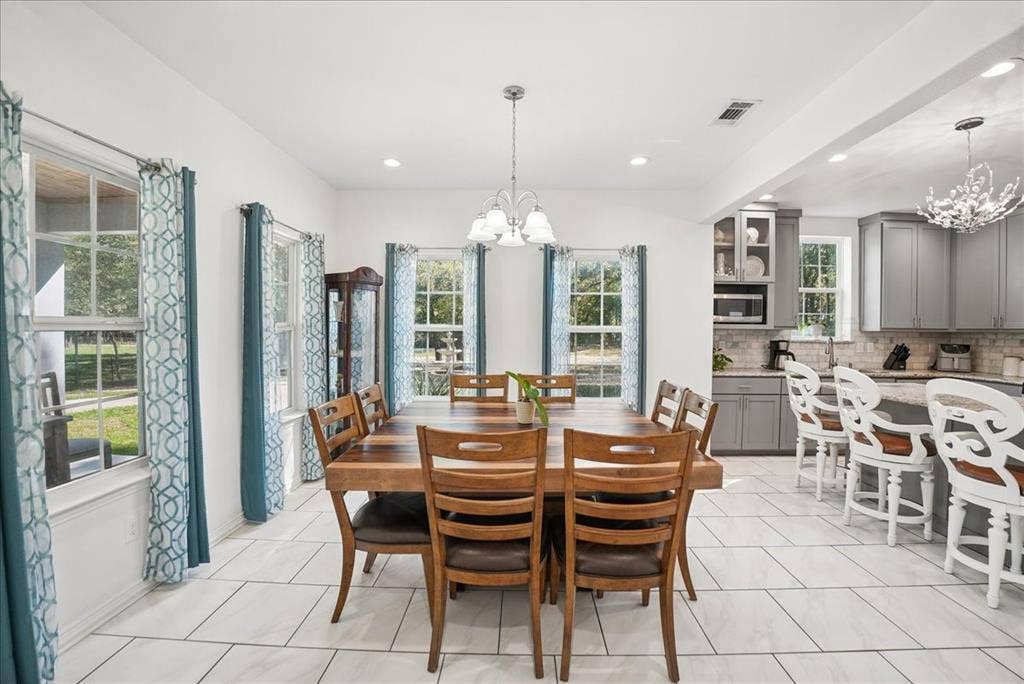 7320 County Road 3512, Quinlan, TX 75474 Dining area featuring large windows with natural light, recessed lighting, and tile flooring