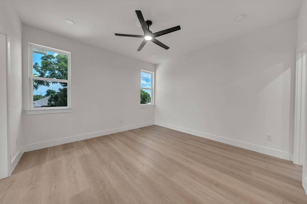 3639 Pueblo Street, Dallas, TX 75212 Neutral interior featuring wood-finish flooring, recessed lighting, double-pane windows, and a matte black ceiling fan