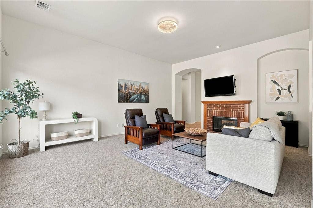 The den features natural light and space for a sectional.