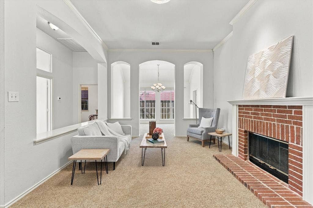 Living area featuring high ceilings, pass through fireplace, and dining room.
