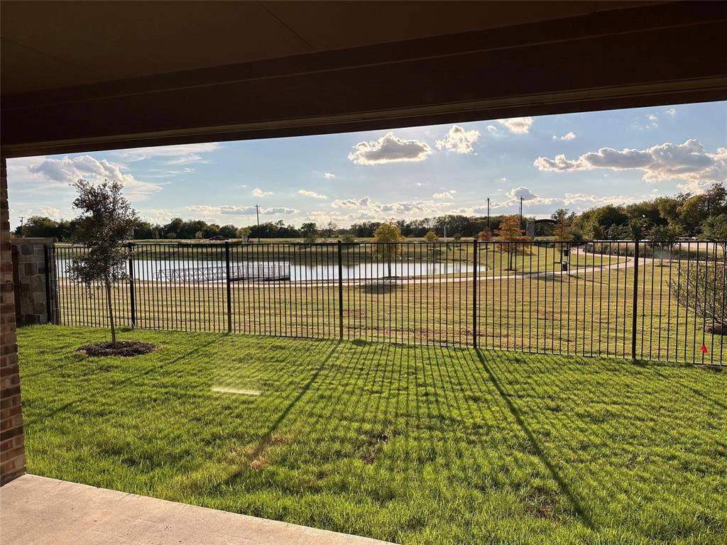 219 Greenshade, Caddo Mills, TX 75135 View of yard with a water view and a patio