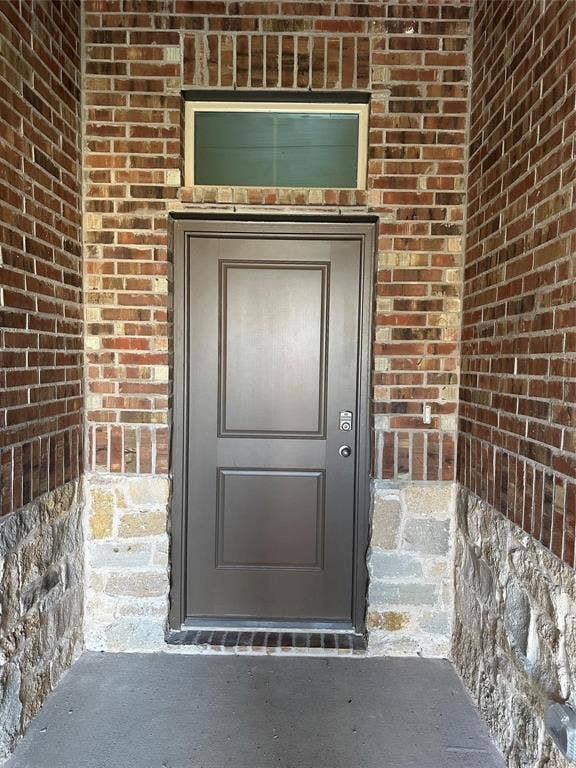 219 Greenshade, Caddo Mills, TX 75135 Property entrance with brick siding