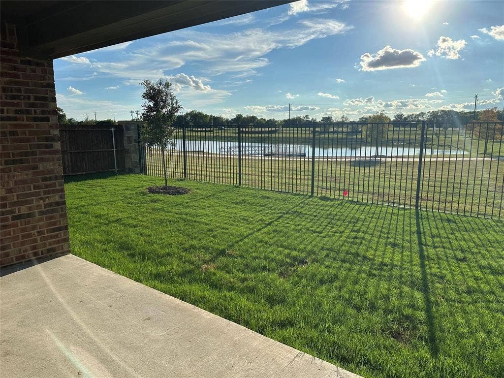 219 Greenshade, Caddo Mills, TX 75135 View of yard with a water view and a patio area