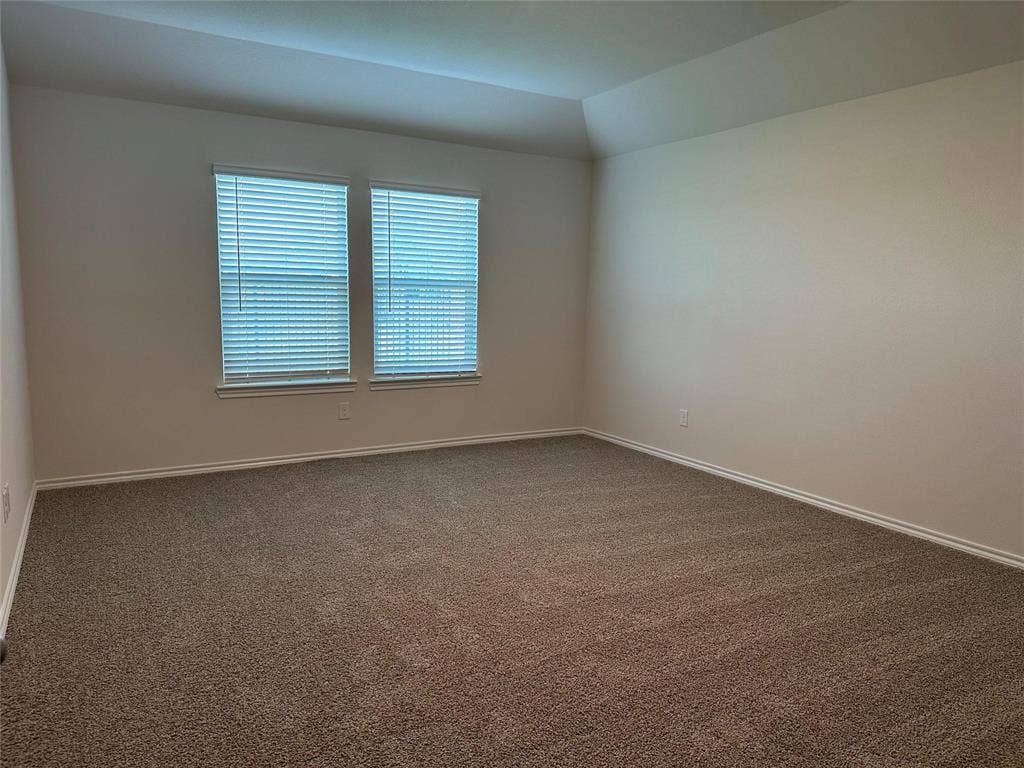 219 Greenshade, Caddo Mills, TX 75135 Unfurnished room featuring carpet flooring and lofted ceiling