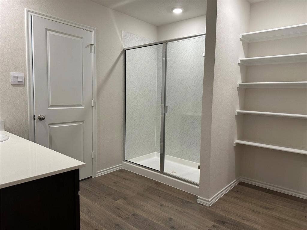 219 Greenshade, Caddo Mills, TX 75135 Full bath with a shower stall, vanity, dark wood finished floors, and a closet