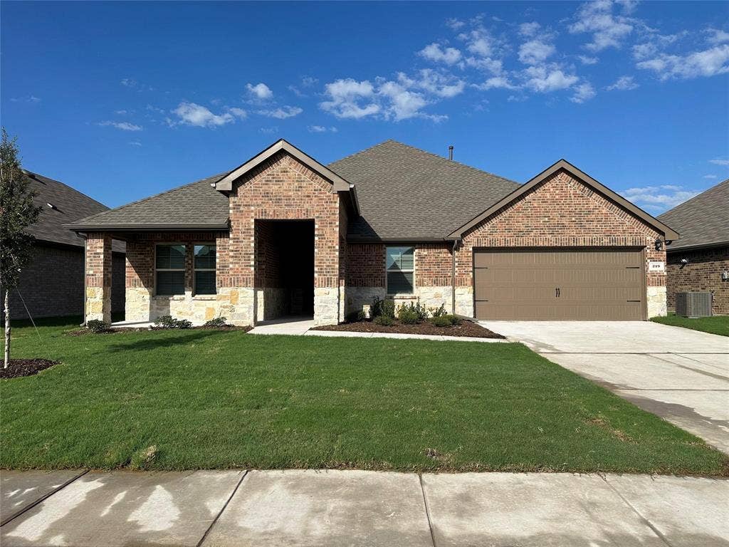 219 Greenshade, Caddo Mills, TX 75135 View of front of property with brick siding, a shingled roof, stone siding, and a front yard