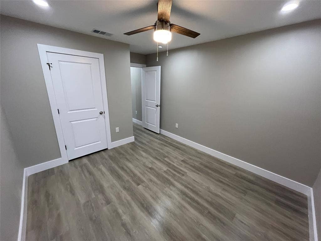 1104 Wake Drive, Richardson, TX 75081 Neutral-toned interior featuring wood-finish flooring, recessed lighting, and a ceiling fan with integrated lighting
