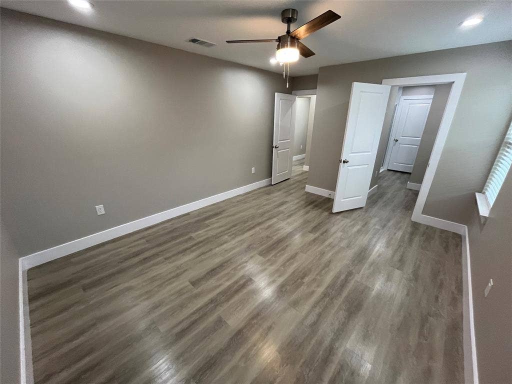1104 Wake Drive, Richardson, TX 75081 Room featuring wood-finish flooring, neutral wall paint, recessed lighting, a ceiling fan with integrated light, and paneled interior doors
