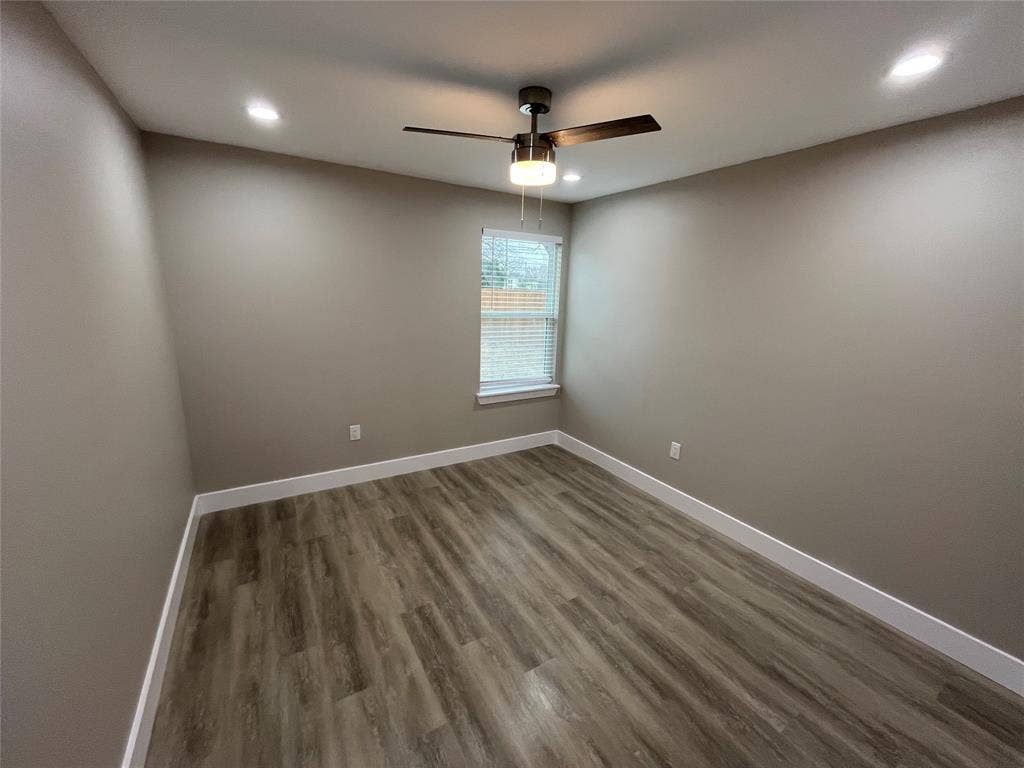 1104 Wake Drive, Richardson, TX 75081 Neutral-toned interior featuring wood-finish flooring, recessed lighting, and a central ceiling fan with integrated lighting