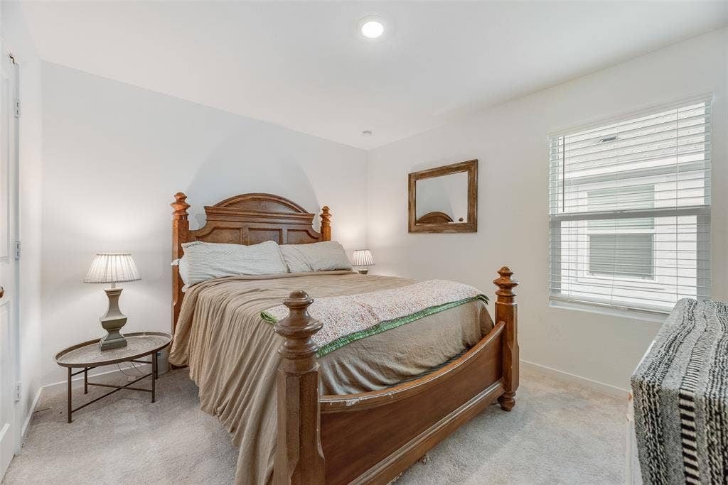 6742 Highlands Street, Princeton, TX 75407 Neutral-toned interior space featuring recessed ceiling lighting, light carpeting, and a window fitted with horizontal blinds