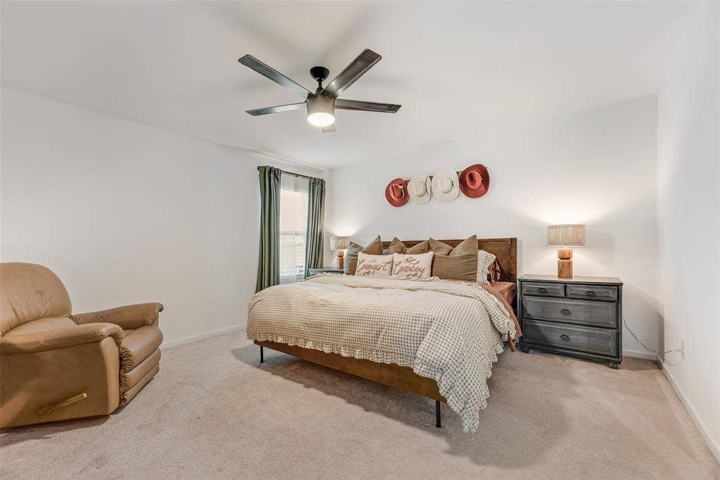6742 Highlands Street, Princeton, TX 75407 Neutral-toned carpeted flooring, window with natural lighting, and ceiling-mounted light fixture with integrated fan